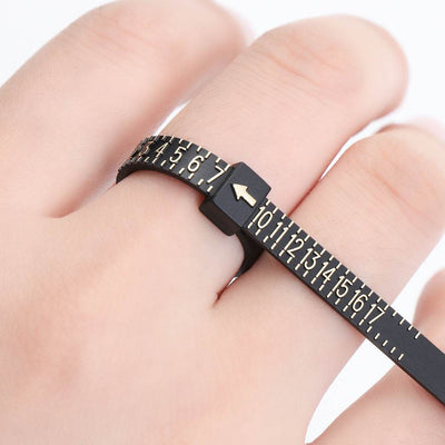 Black plastic ring measuring ruler tape for finger size measurement on hand with numbers 1 to 17