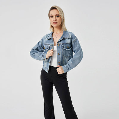 Woman wearing blue denim long sleeve jacket with button front and collar paired with black pants